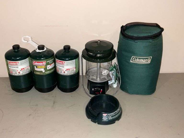 Coleman propane lantern and 3 propane bottles image