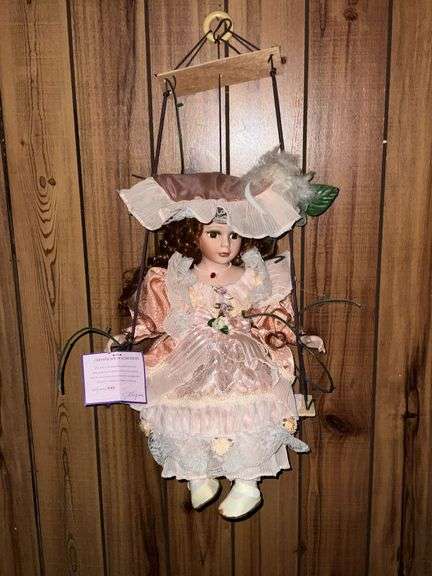 Porcelain doll on a swing "Kate" with COA image