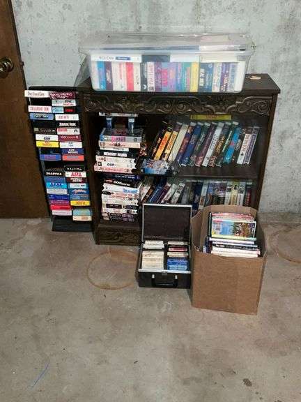 Cabinet with collection of VHS, 8-track tapes, DVDs