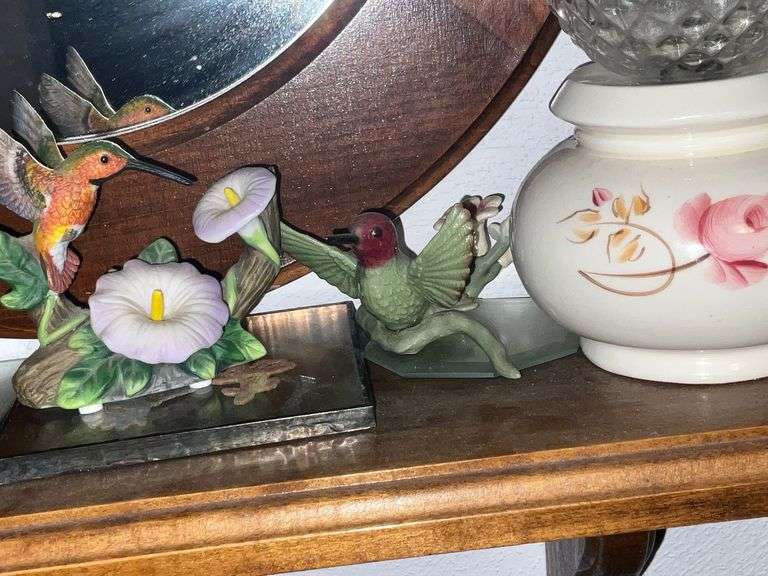 Oval mirror with small shelf and decorations