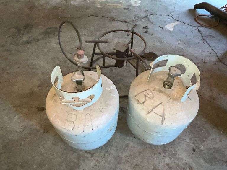 2 propane bottles, one partially full and a burner image