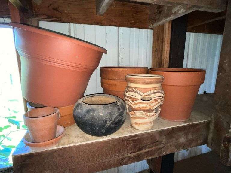 Assortment of plastic and clay flower pots image
