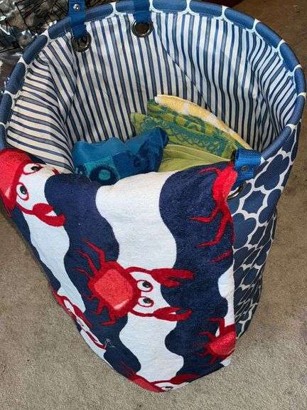 Clothes hamper with assorted beach towels image