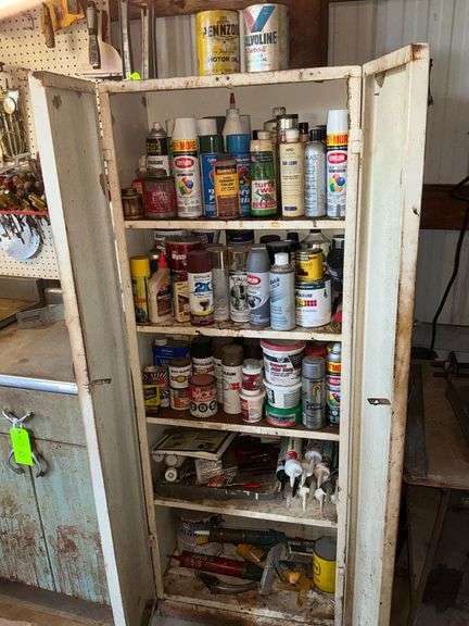 Metal cabinet with assortment of chemicals, spray paint image