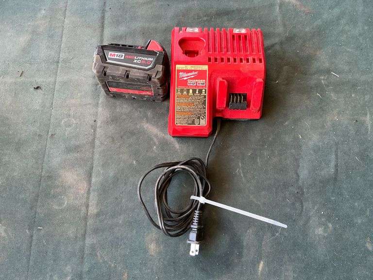 Milwaukee 18 volt XC5 battery and charger. image