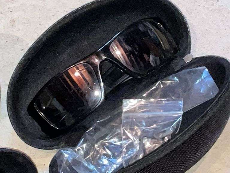 2 pairs of Oakley sunglasses in cases image