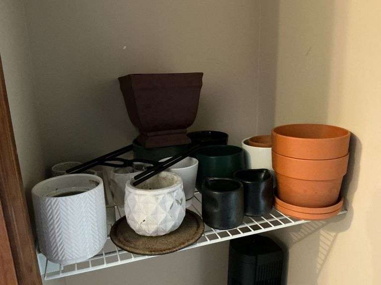 Assortment of flower pots and stands image
