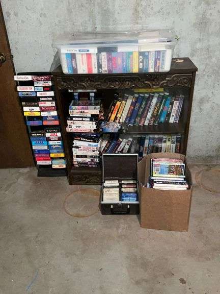 Cabinet with collection of VHS, 8-track tapes, DVDs