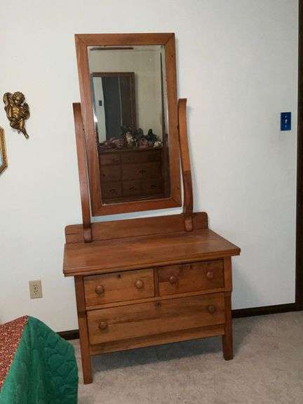 Three-drawer antique dresser with mirror, split in side image