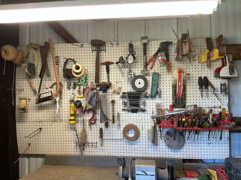 Peg board and tools, wrenches, hammers, bow saw image