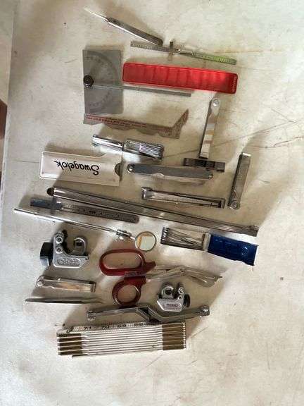 Feeler gauges, folding ruler, magnifying glass image