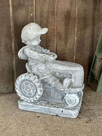 Little boy on tractor, concrete image