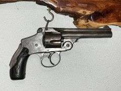 "We Don't Call 911" plaque with non-working Smith & Wesson revolver