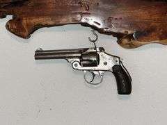 "We Don't Call 911" plaque with non-working Smith & Wesson revolver
