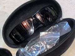 2 pairs of Oakley sunglasses in cases