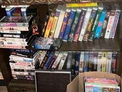 Cabinet with collection of VHS, 8-track tapes, DVDs