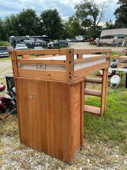 Wooden captain's quarters with 1 mattress, desk and ladder image