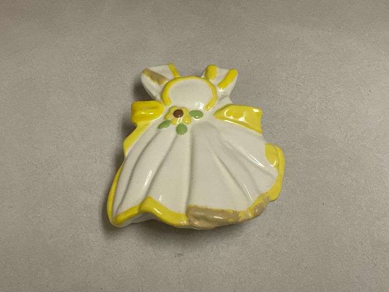 White apron with yellow trim wall pocket, paint has been retouched, marked "LH" on the back image