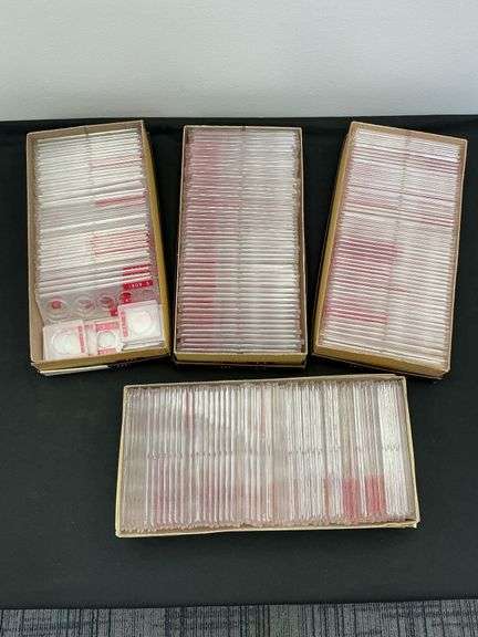 Plastic coin holders in boxes image