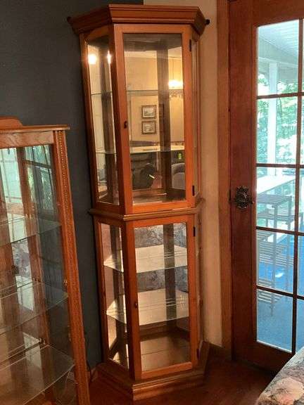Corner curio cabinet with glass shelves, lighted image