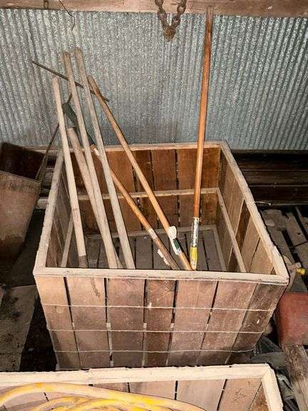Wooden box of long handled tools image