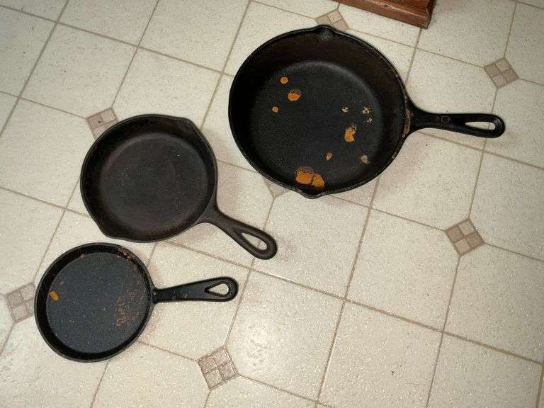 Lodge cast iron skillet, 2 smaller unmarked skillets image