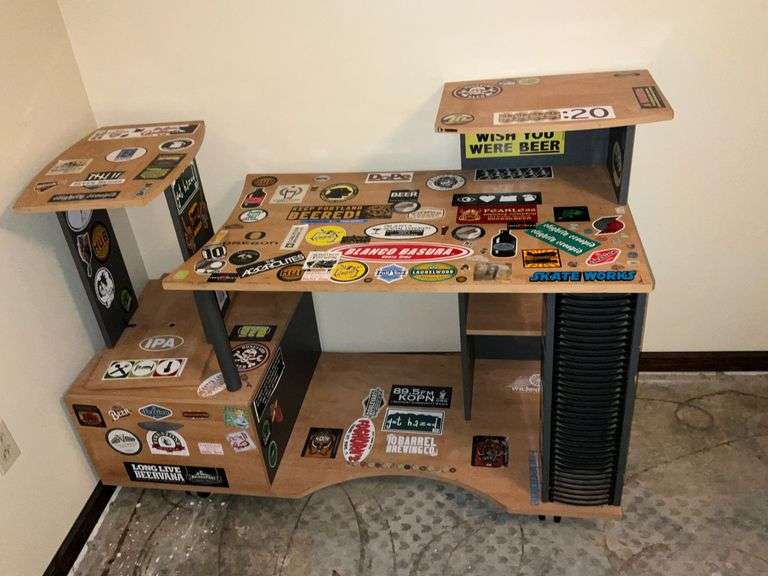 Computer desk with lots of stickers image