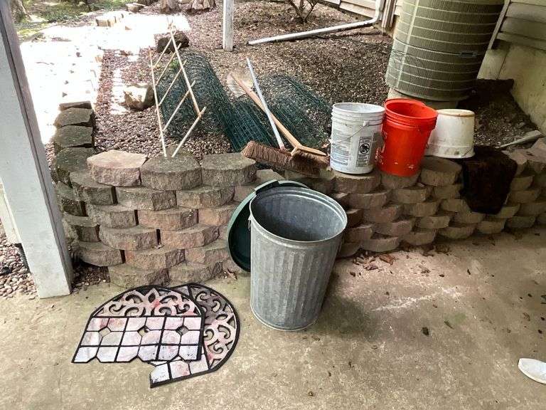 Assortment of yard supplies, garden fence, buckets image
