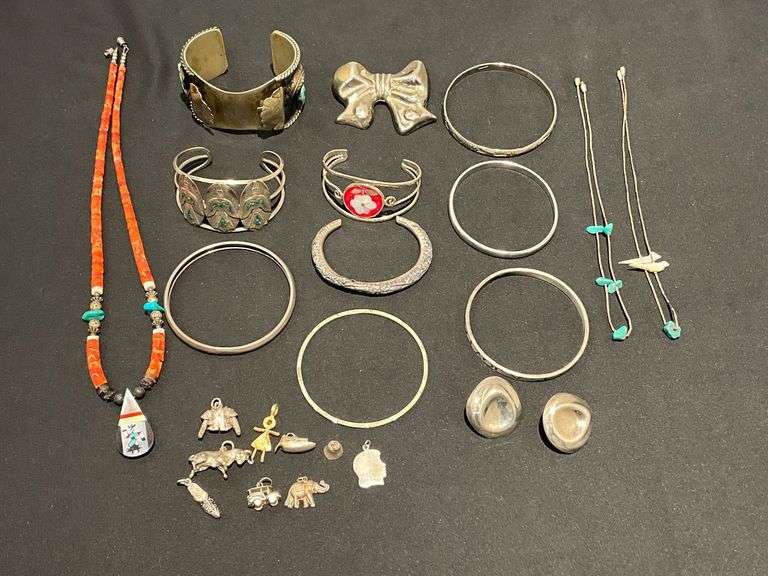 Bangles, cuffs, pins, charms. Possibly silver, but no marks found. image