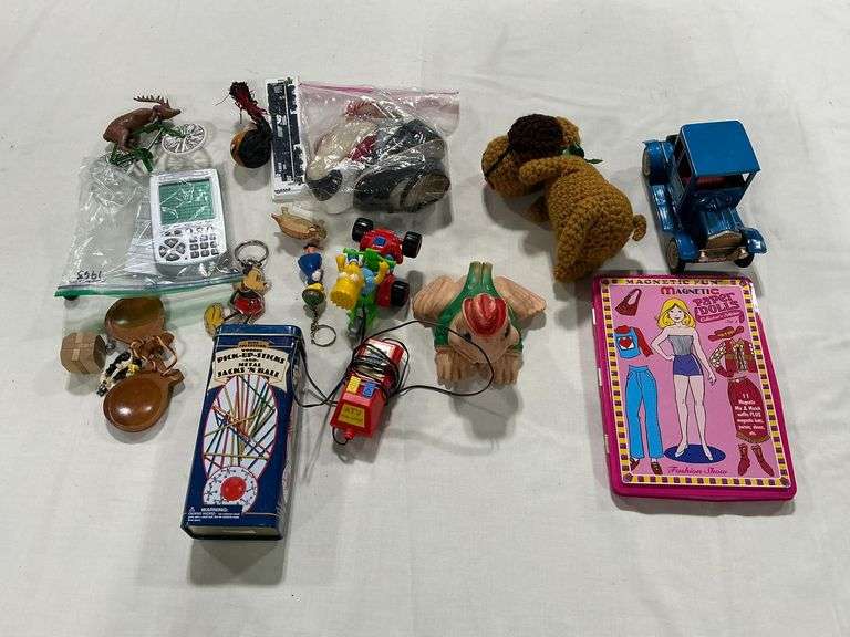 Plastic frog, pickup sticks, tin car, etc. image