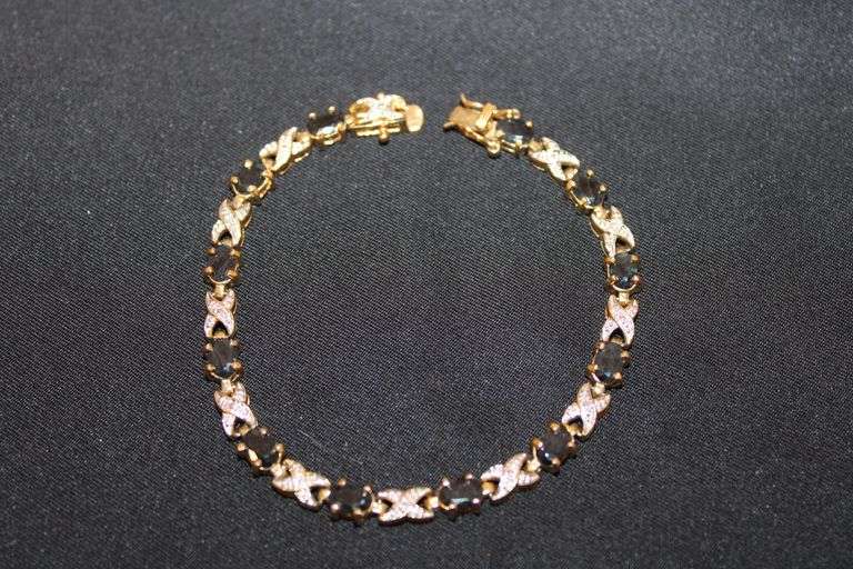 Gold over sterling 7" tennis bracelet with sapphire? stones image