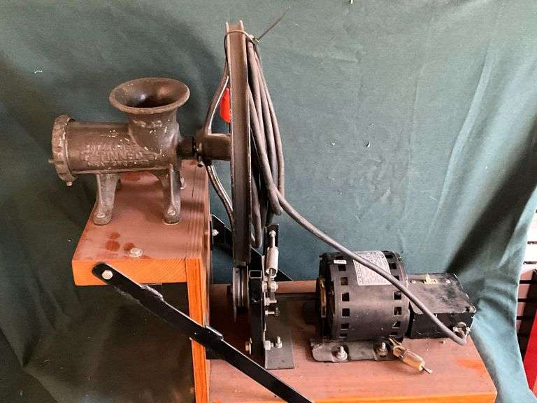 Enterprise No. 12 food grinder mounted on platform with electric motor. image