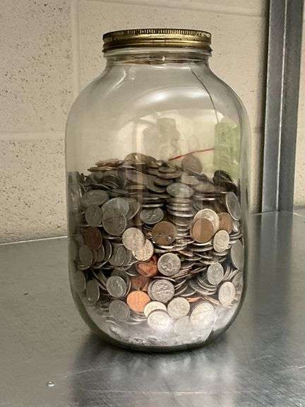 Gallon jar over half full of change image