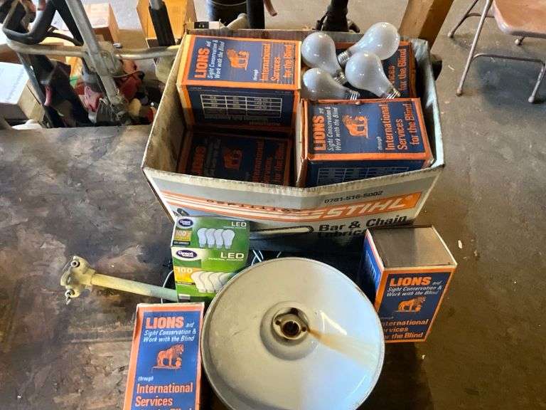 Metal enamel coated light fixture and assortment of light bulbs. image