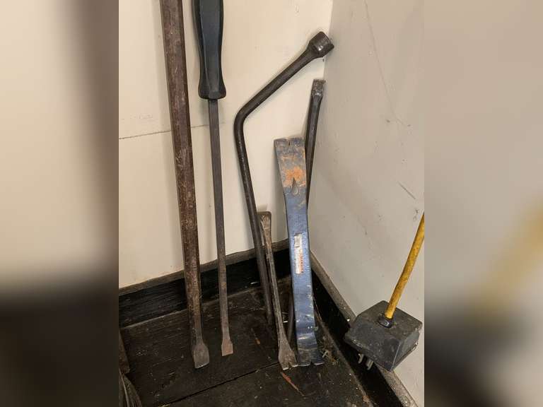 ASSORTMENT OF TIRE IRONS & CROW BARS - GARAGE CLOSET image