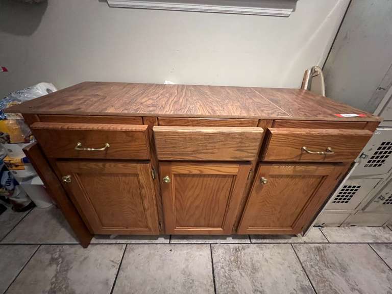 Laundry… Wooden cabinet, some content, has three doors and two drawers for storage, see pictures for details. image