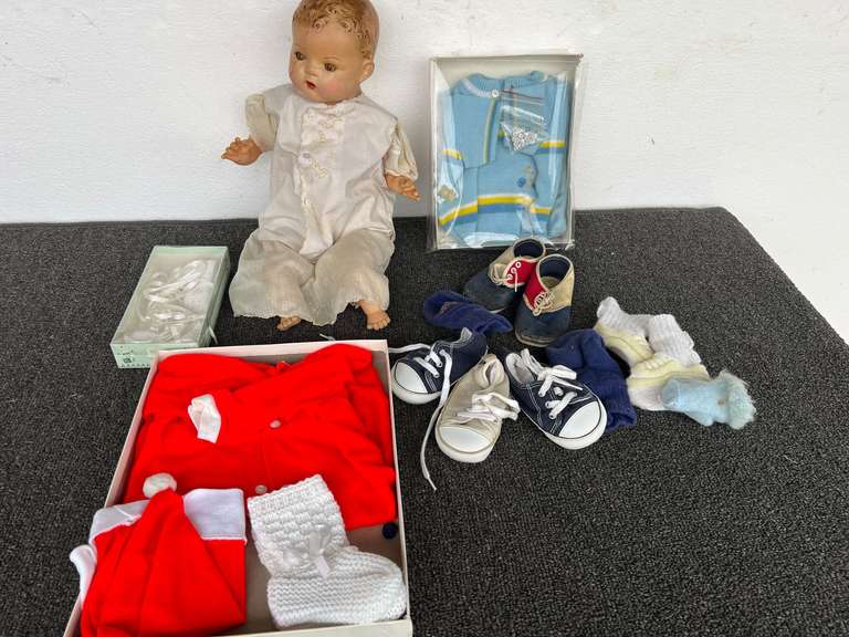 Assorted baby items to include shoes, sweater, infants knit set, and a vintage composition doll, see pictures for details. image