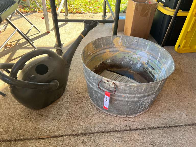 Galvanized tub with metal washboard, also includes a watering can, see pictures for details. image