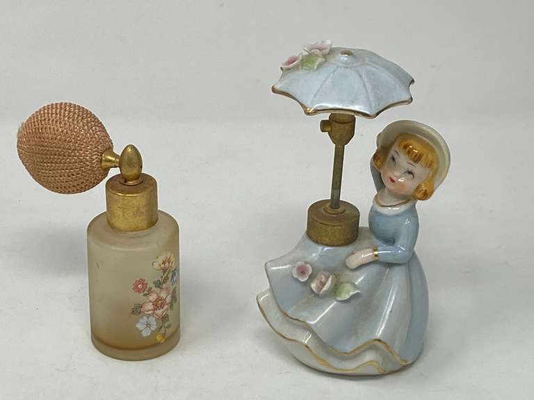 Vintage DeVilbiss figural porcelain perfume atomizer bottle featuring a girl with an umbrella and flowers. Also includes a vintage frosted glass perfume atomizer with a floral design. Tub is not included, see pictures for details. image
