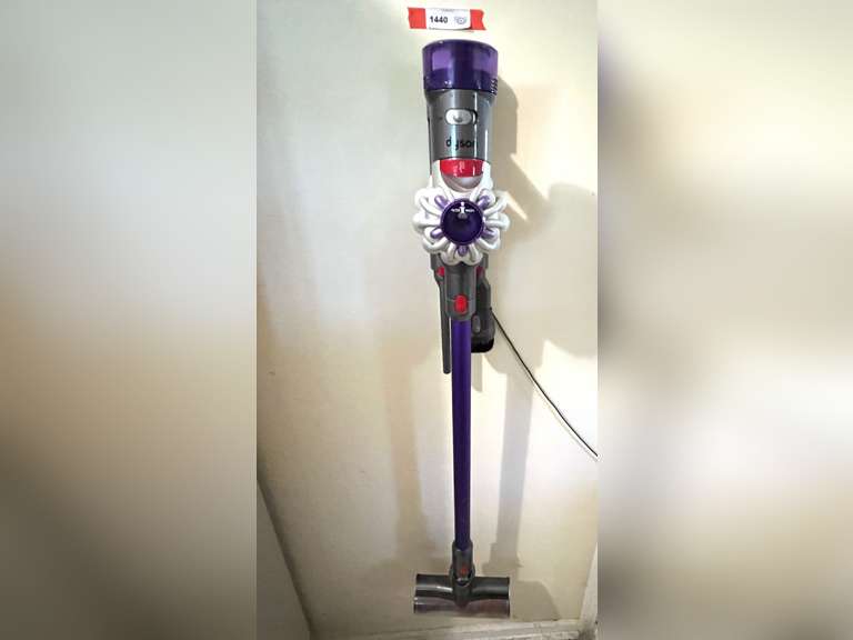 Laundry…Battery powered Dyson vacuum cleaner, comes with mount and charger, powers up, see pictures for details image