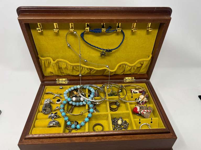 Vintage ladies jewelry box filled with ladies fashion estate jewelry to include rings, bangle bracelets, necklaces, cuff watch, and more. See pictures for details. ￼ image