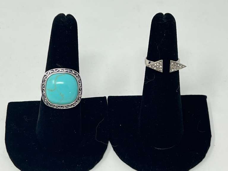 Ladies silver rings, both pieces are stamped 925, includes an open cuff ring with triangular ends, and one with a large cabochon, believed to be turquoise. See pictures for details. ￼ image