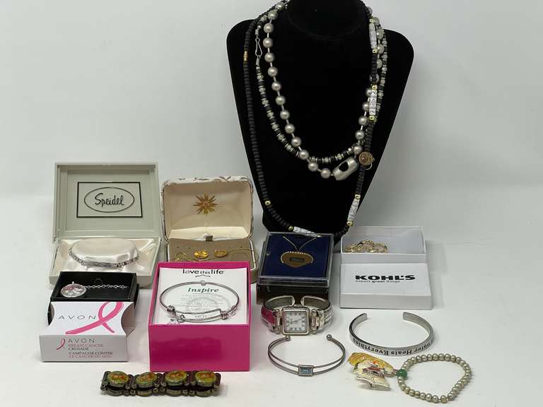 Round wooden storage/pantry box filled with assorted lady fashion estate jewelry to include necklaces, cuffed bracelet, cuff watch, brooch, and more. See pictures for details. ￼ image