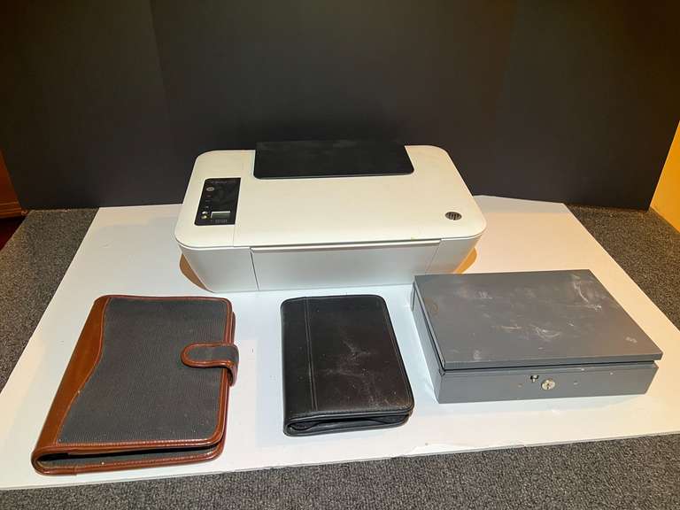 BR3…Shelf lot marked 1564 to include an HP DeskJet 2544, working condition unknown, daily planners, and cash box. See picture for details. image