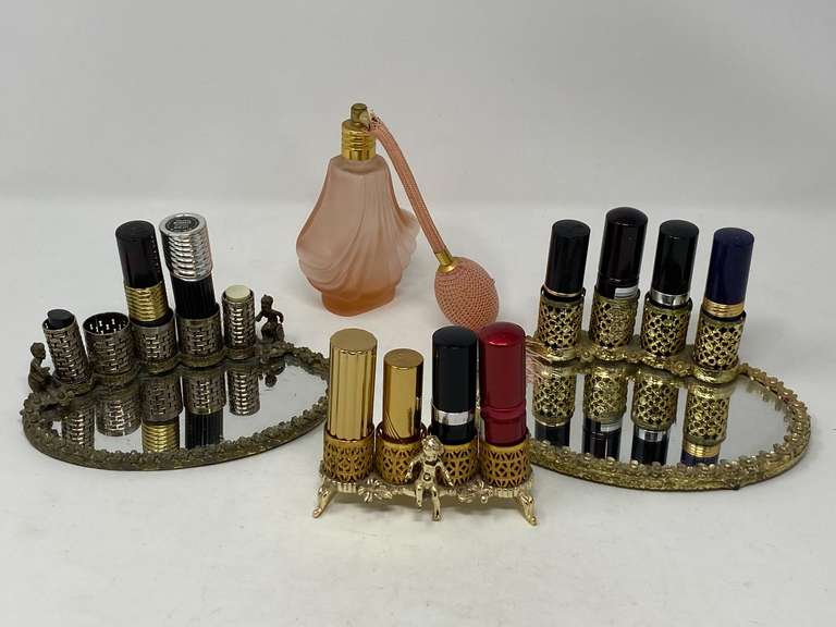 Vintage lipstick holders, two with mirrored trays, also includes a frosted pink perfume bottle with bulb, see pictures for details. ￼ image