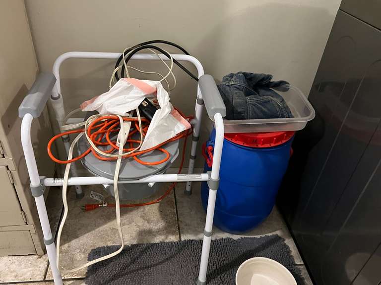 Laundry… Assorted household items to include a bedside toilet, extension cords, plastic storage barrel with lid, vintage clothes pin bag, and more. See pictures for details. image