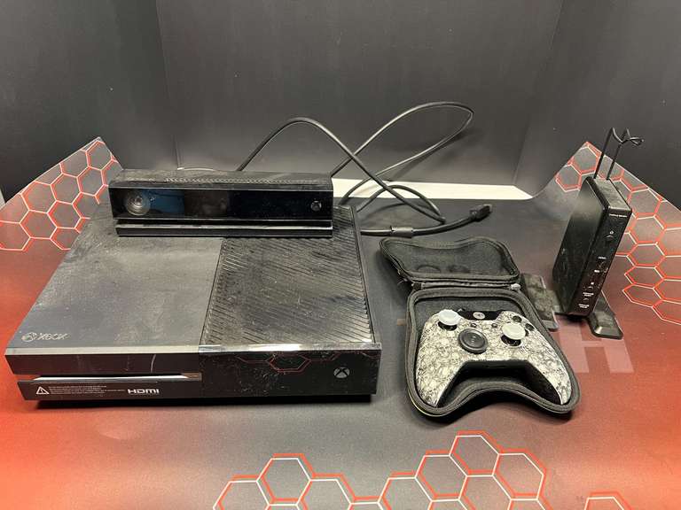 Assorted items to include an Xbox one console, working condition unknown, assorted cords, desk mat, and more. image