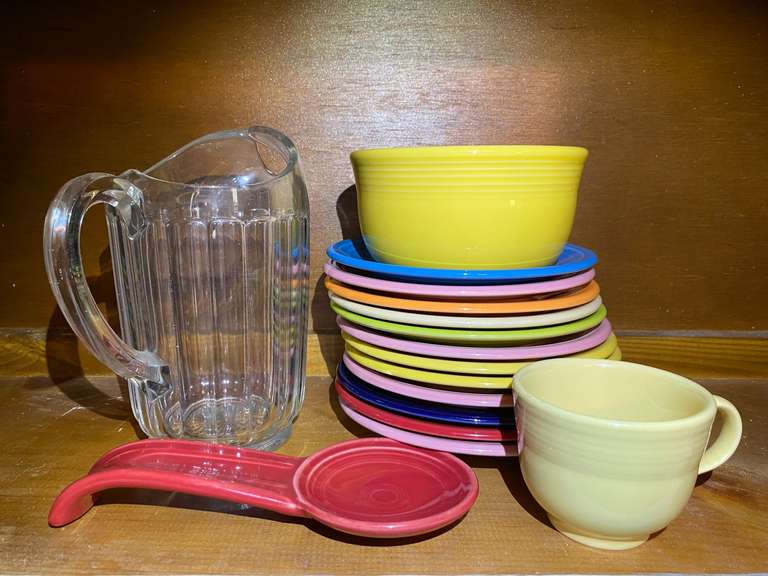 KIT… Assorted Fiestaware to include salad plates, bowl, cup, spoon rest, also includes a vintage glass pitcher, see pictures for details. image