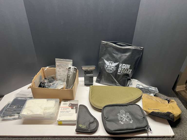 DEN… assortment of firearm accessories to include a red laser site, small assortment of ammunition, soft sided pistol cases, and more. Tub is not included, see pictures for details. image