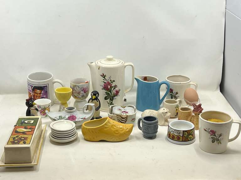 KIT… Shelf lot marked 1194, includes all content of this shelf. Items include vintage salt and pepper shakers, egg cups, ceramic shoe, vintage small electric porcelain teapot with rose motif, no cord, and much more. See pictures for details. image